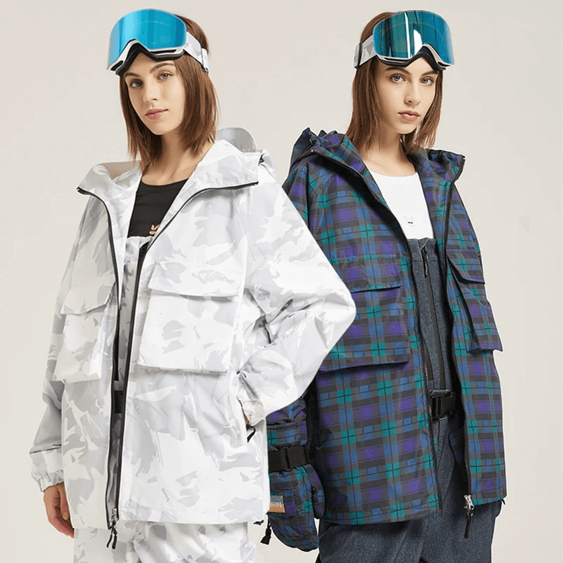 Two women wearing thick warm skiing jackets with two-way zips and large pockets, in plaid and camo designs, perfect for winter sports.